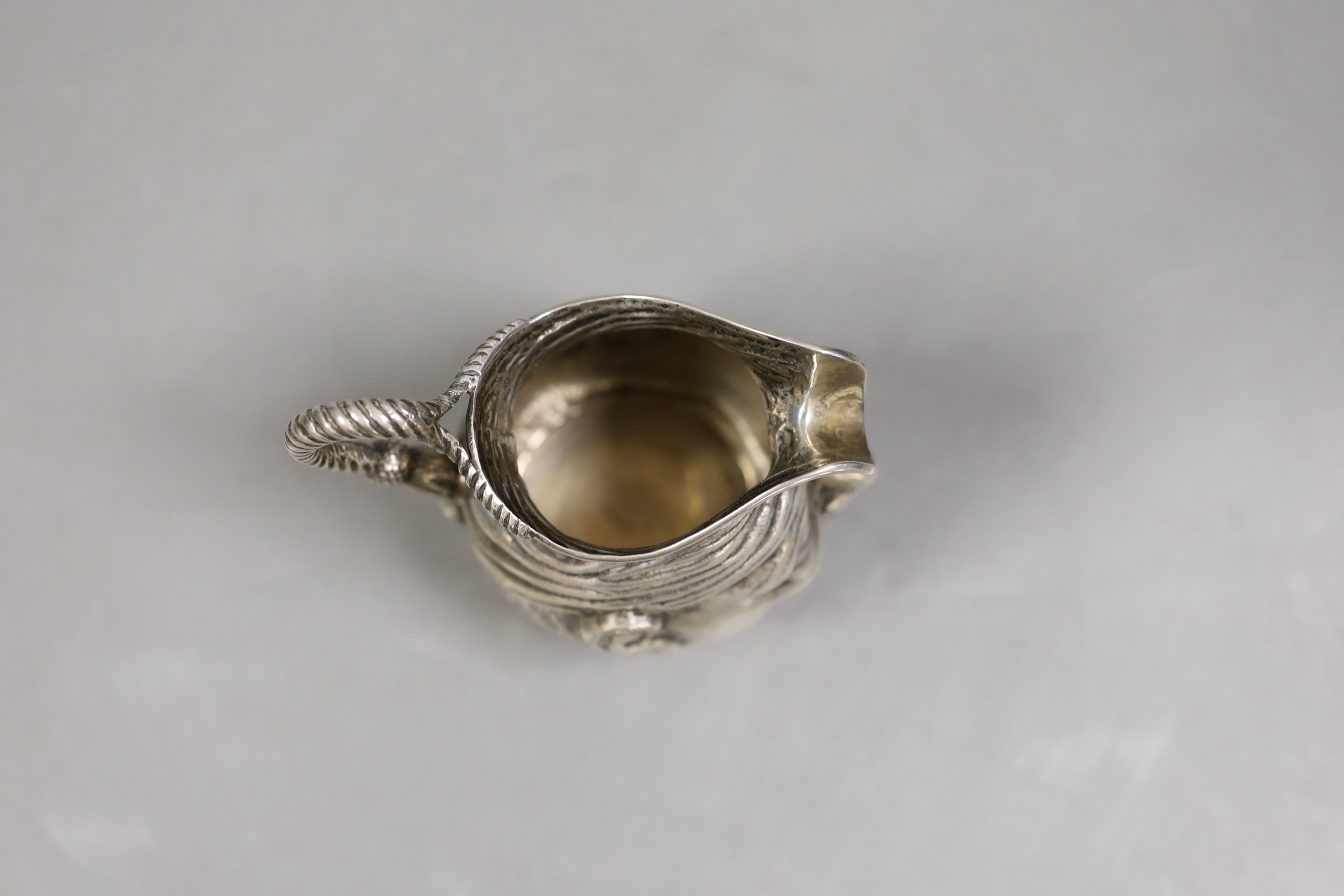 An Edwardian novelty silver 'character' cream jug, Williams Ltd, Birmingham, 1905, 93mm, 100 grams.
